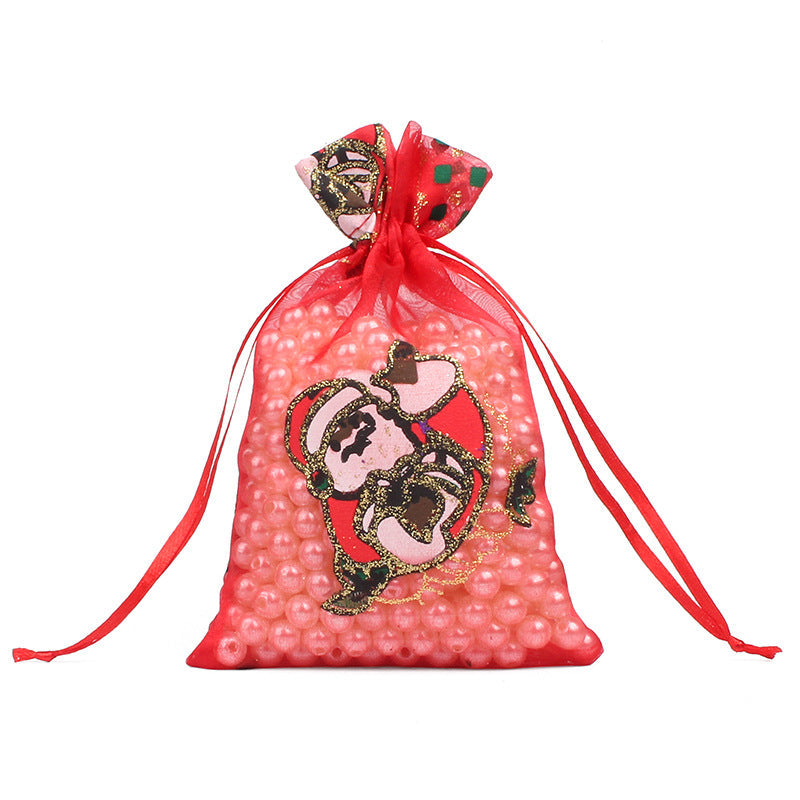 Sheer organza Christmas gift bags with red ribbon ties and festive print
