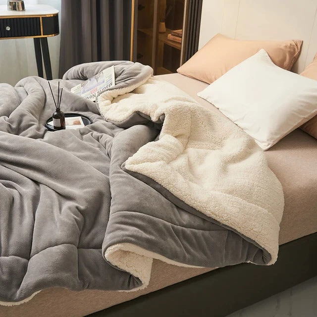 Sherpa blanket with quilted channels on a made bed - grey