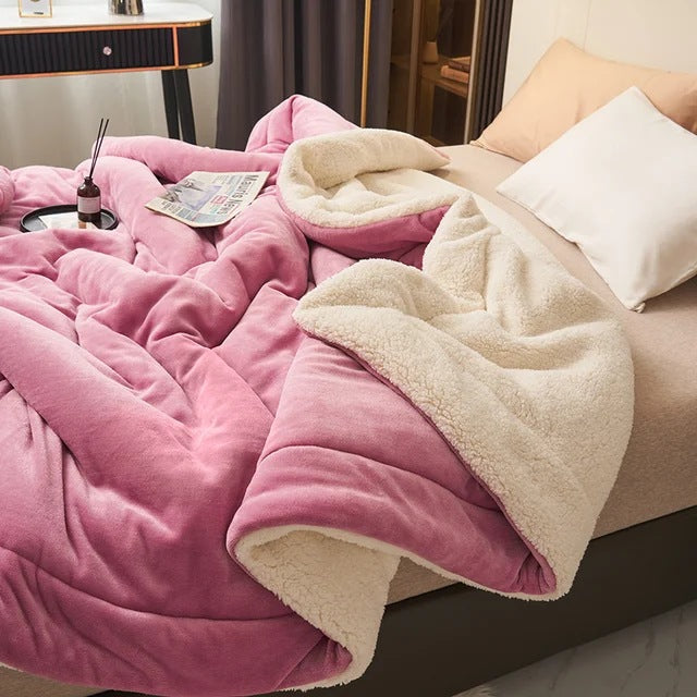 Sherpa blanket with quilted channels on a made bed - magenta