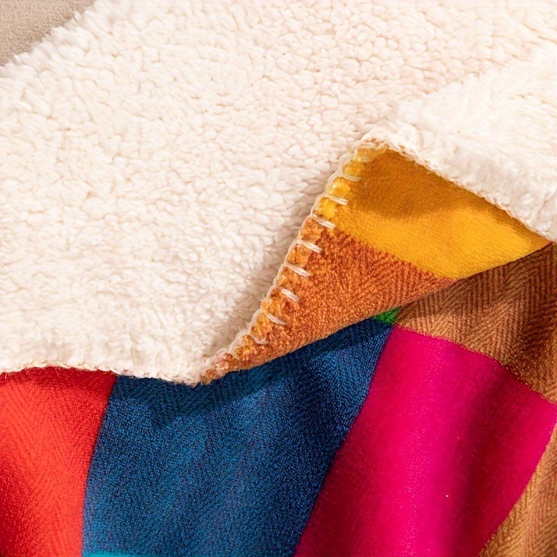 Sherpa throw with a colourful check pattern on a bed - view 3