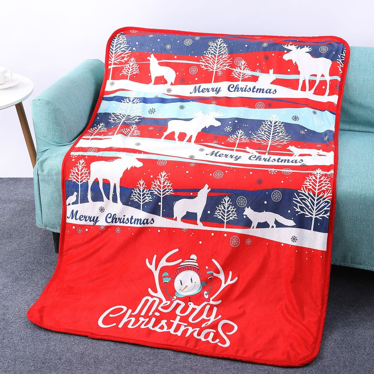 Soft Christmas blanket with a festive print, draped over a sofa