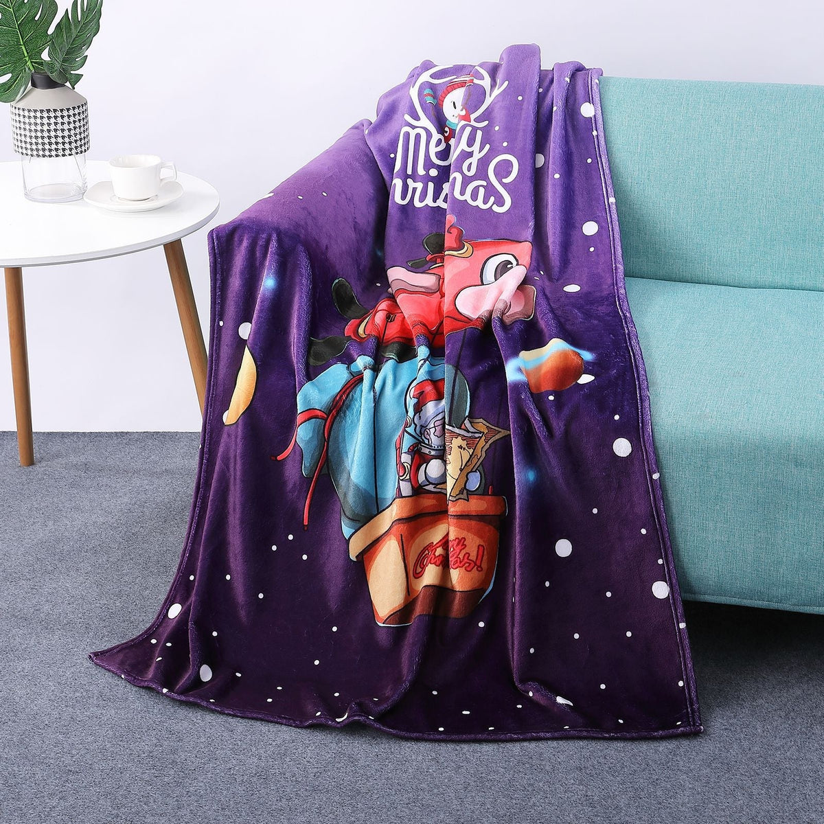 Soft Christmas blanket with a festive print, draped over a sofa