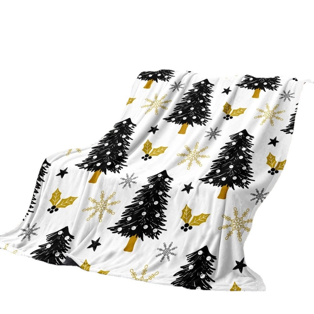 Soft fleece Christmas blanket with an all-over festive print on a sofa