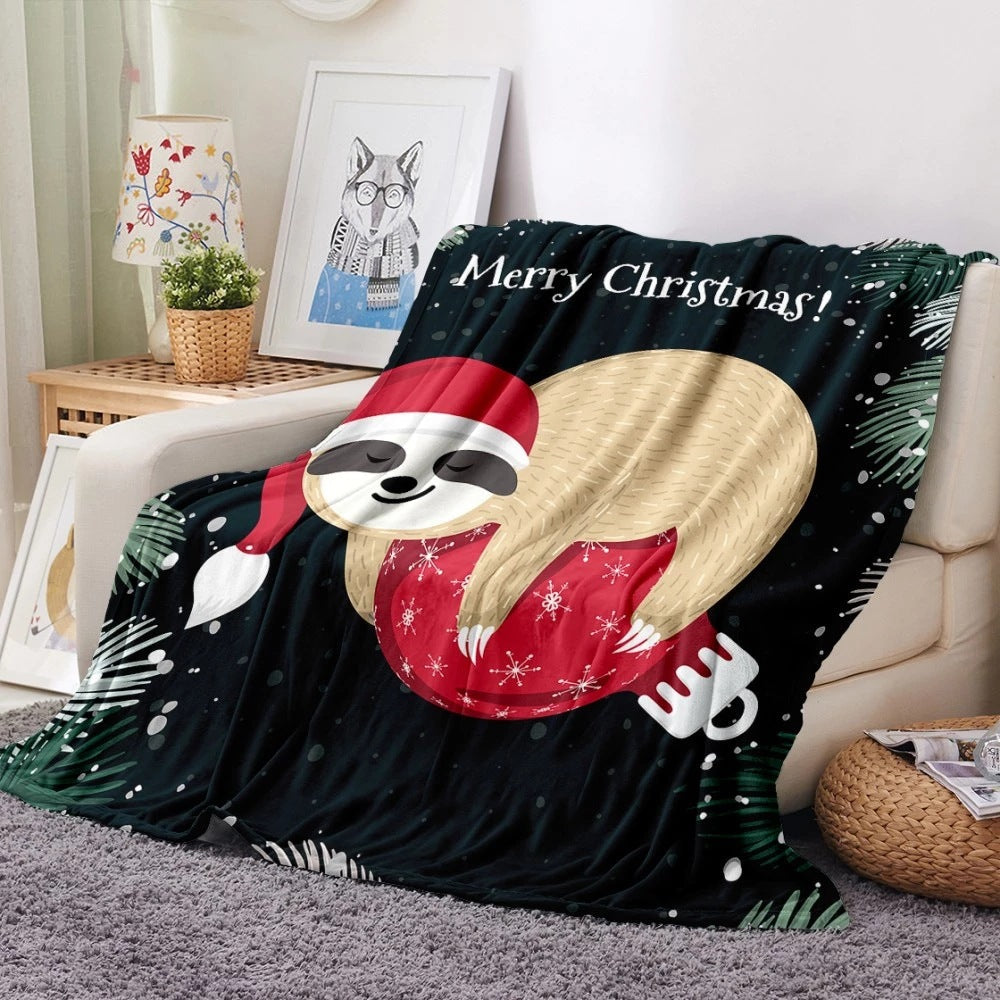 Soft fleece Christmas blanket with an all-over festive print on a sofa - black sloth