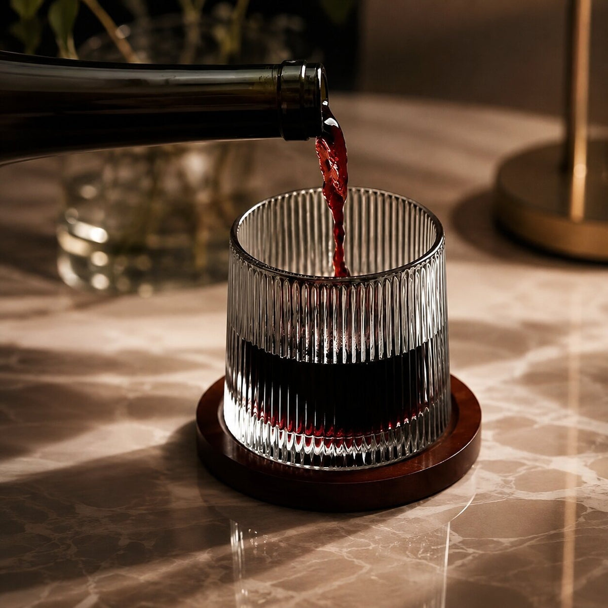 Spinning whisky glass with a rounded base and a wooden coaster - view 3
