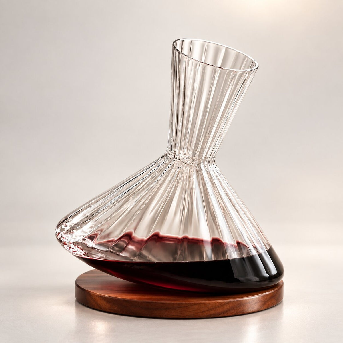 Spinning ribbed glass wine decanter on a round coaster
