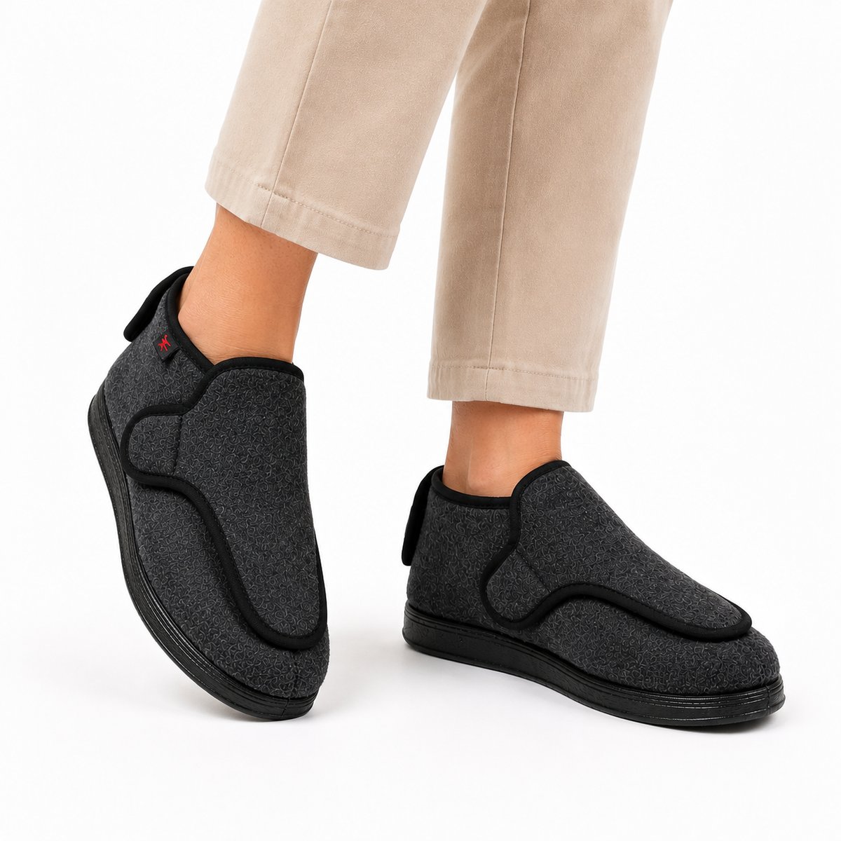 Wide-fit house shoes with an adjustable wrap-over strap and a pull tab