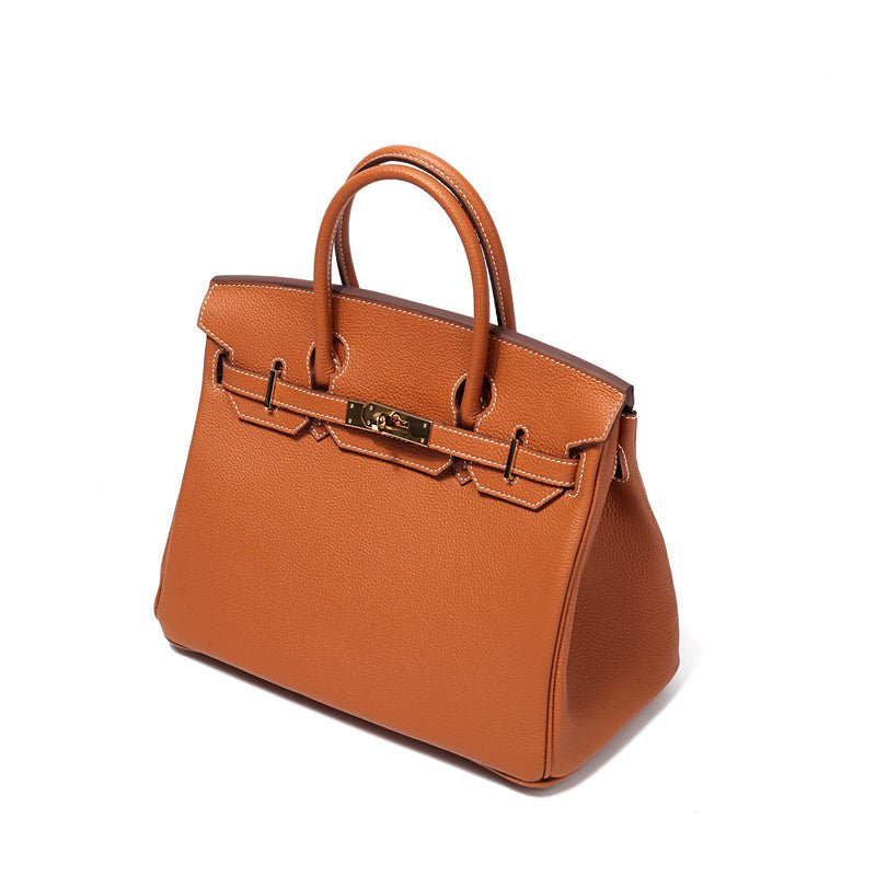 Structured top handle bag with two rolled handles, a flap with turn lock and a padlock