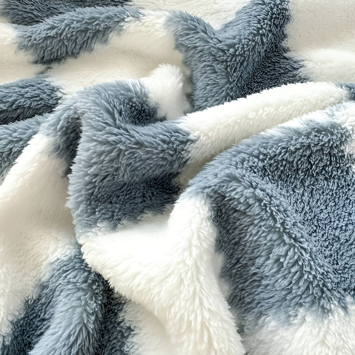 Teddy fleece blanket with a checkerboard pattern, folded in someone's arms - view 2