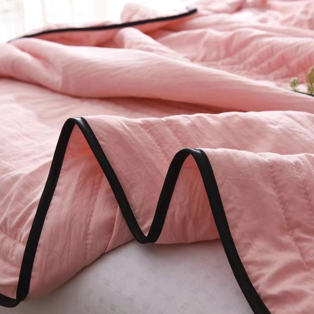 Thin quilted summer blanket with piping on a made bed - view 4
