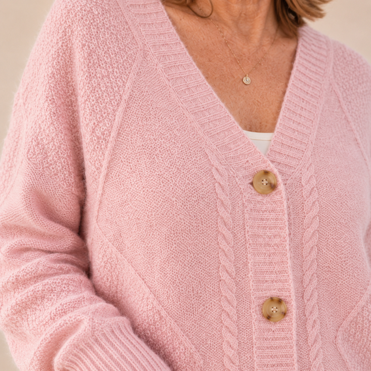 Women's V-neck cable knit cardigan with a button front