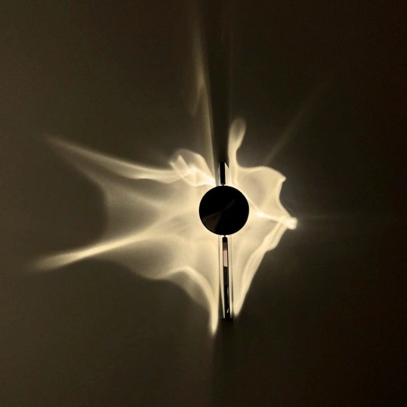 Wall light with a round disc casting a rippled light pattern on the wall - view 4