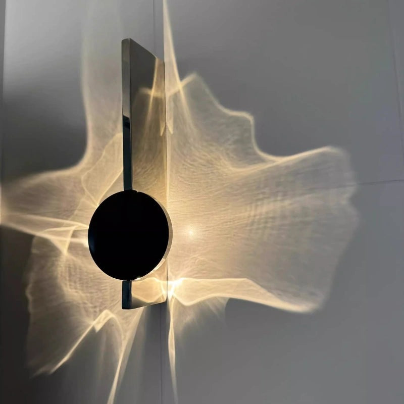 Wall light with a round disc casting a rippled light pattern on the wall - view 5
