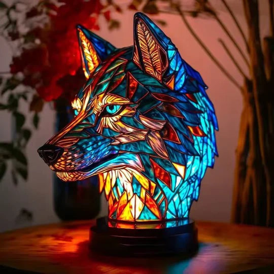 Wolf head lamp in a stained glass look in blue and orange with light blue eyes on a round base