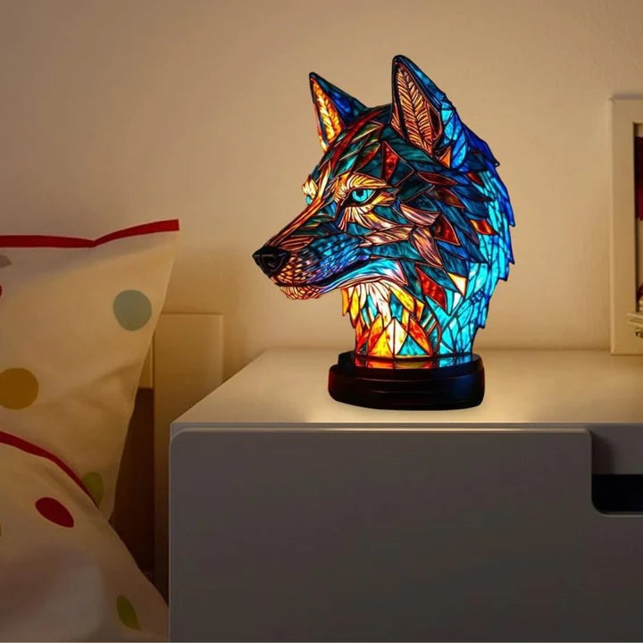 Wolf head lamp in a stained glass look in blue and orange with light blue eyes on a round base