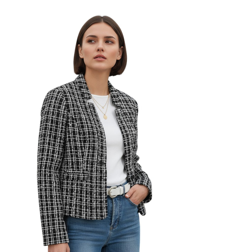 Collarless tweed jacket with a frayed trim, worn open in black and white