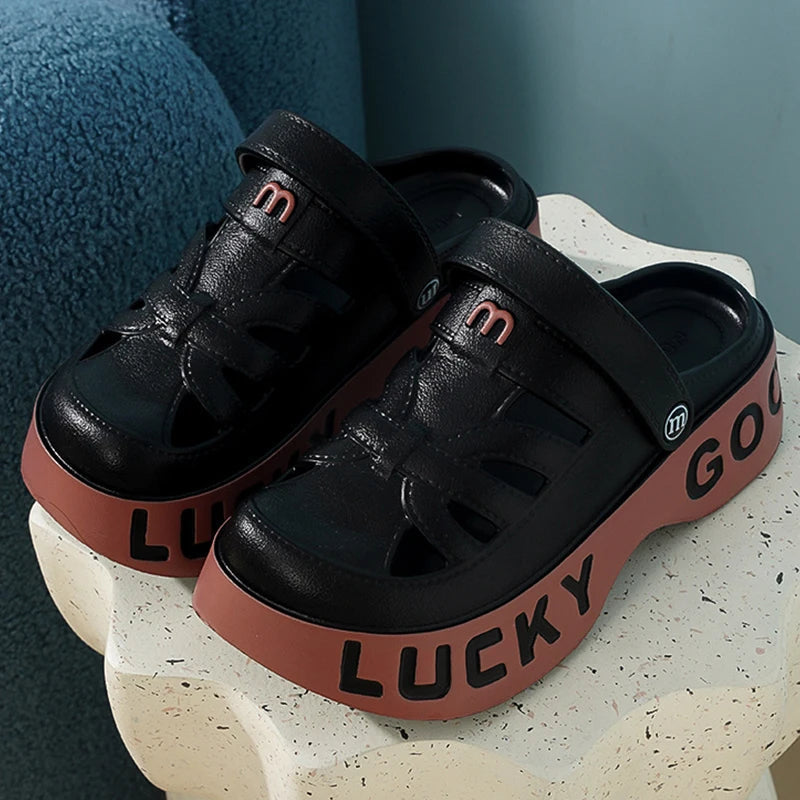 Closed-toe sliders with cut-outs, pivoting heel strap and thick platform sole with lettering - view 2