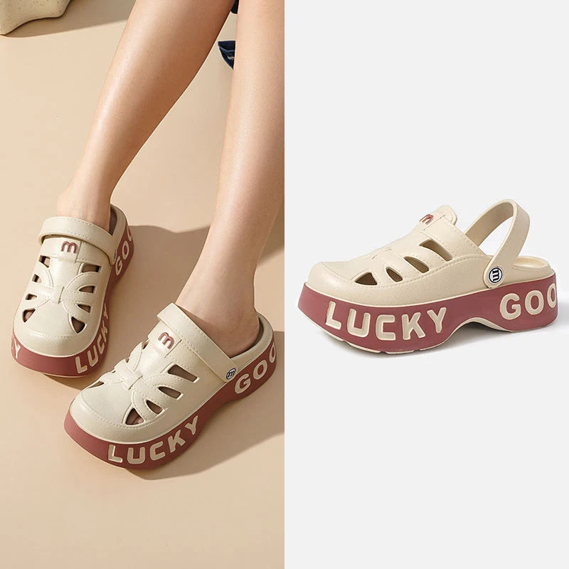 Closed-toe sliders with cut-outs, pivoting heel strap and thick platform sole with lettering - cream