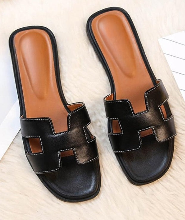 Women's flat sandals with a wide cut-out strap, contrast stitching and an open toe - black