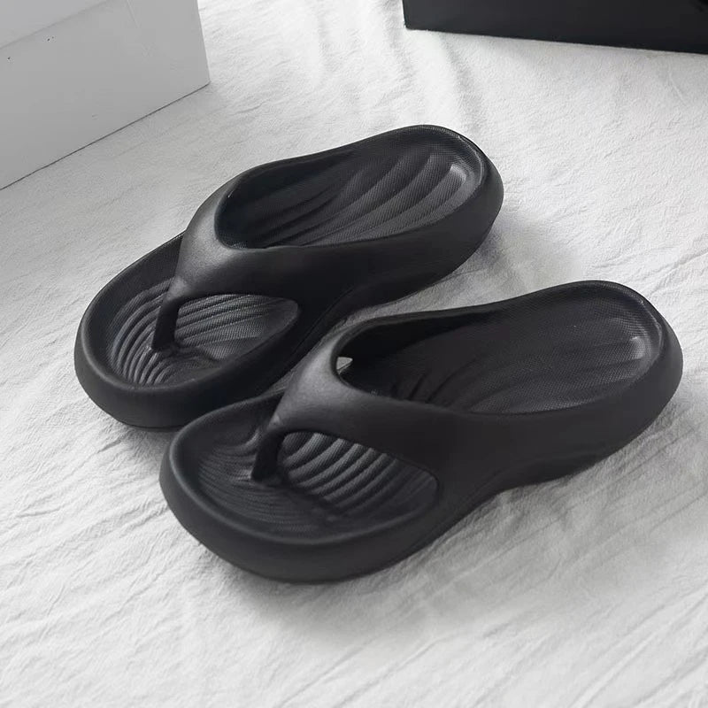 EVA flip flops with a ridged footbed and a thick curved sole - black