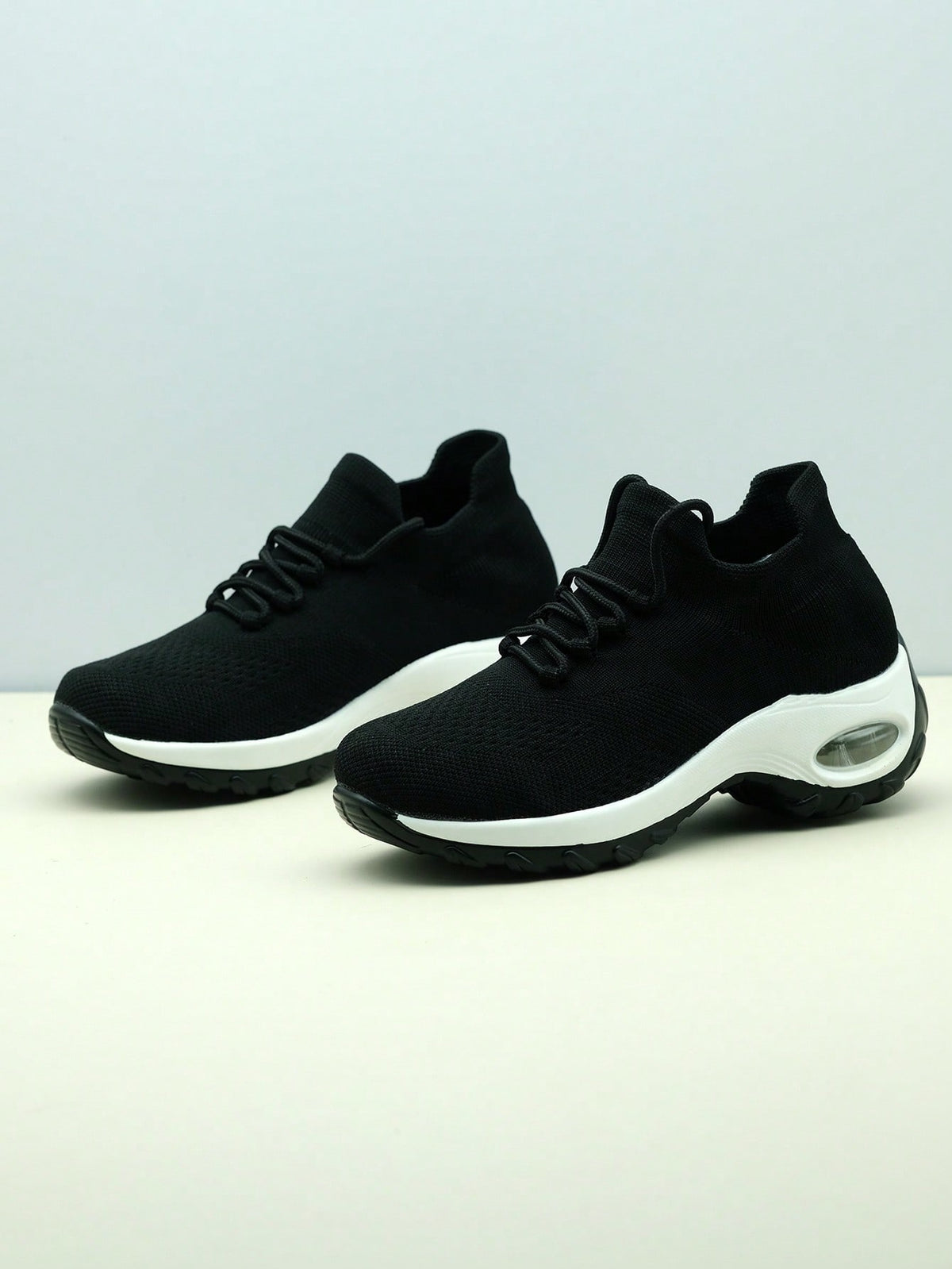Slip-on trainers for women with knit sock collar, decorative laces and thick air cushion sole - black/white