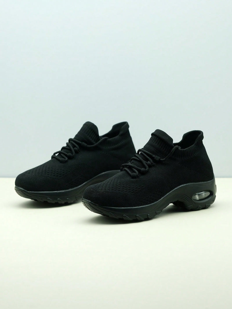 Slip-on trainers for women with knit sock collar, decorative laces and thick air cushion sole - black