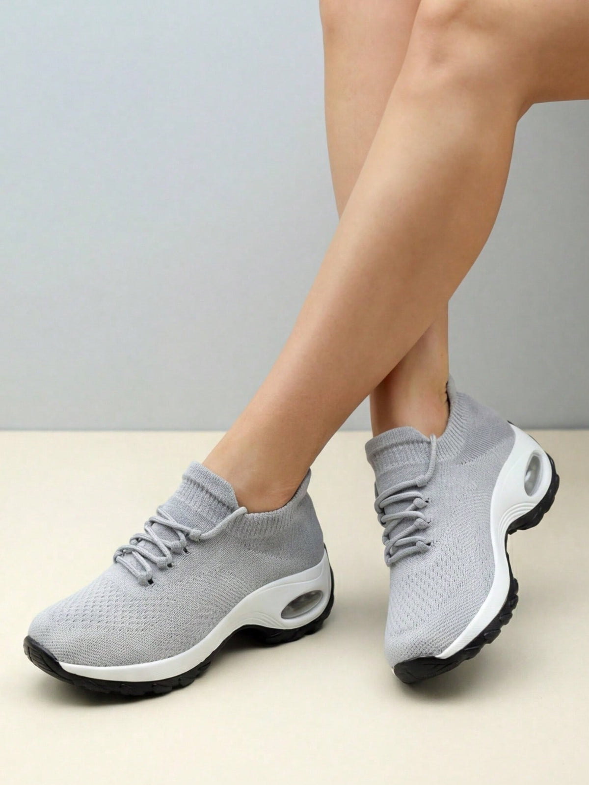 Slip-on trainers for women with knit sock collar, decorative laces and thick air cushion sole - light grey