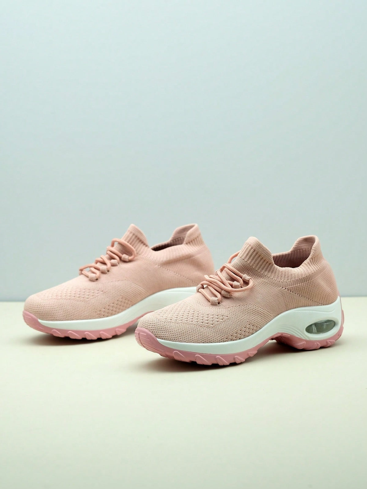 Slip-on trainers for women with knit sock collar, decorative laces and thick air cushion sole - light pink
