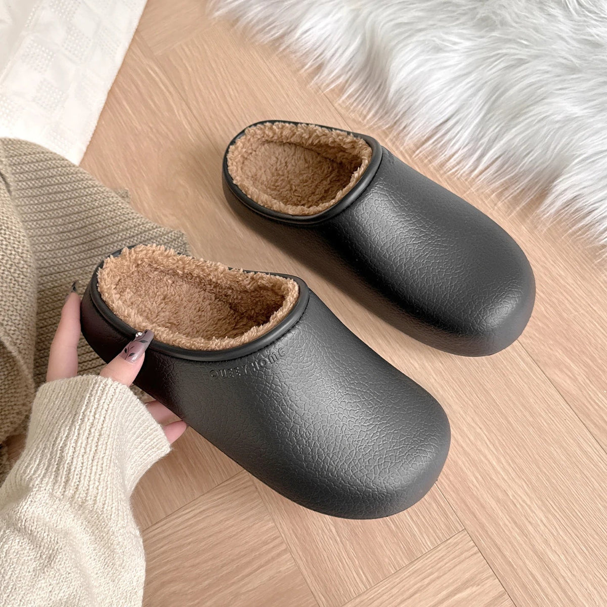 Slippers with a smooth grained upper, plush lining and open heel