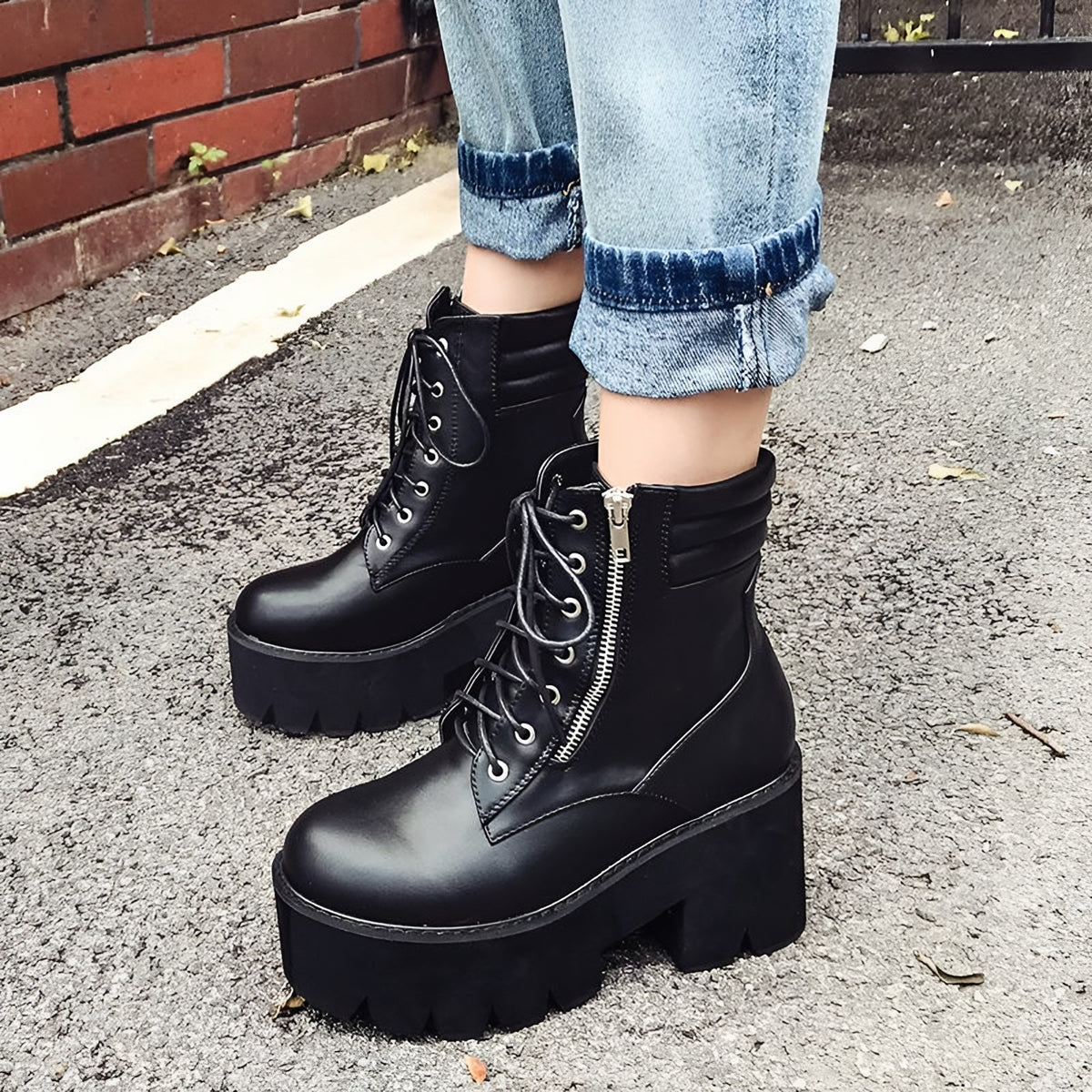 Black platform ankle boots worn with cropped jeans