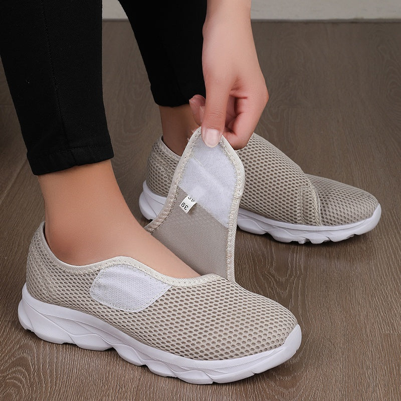 Wide fit mesh shoes for women with broad hook and loop strap over the instep and flat tread sole - beige